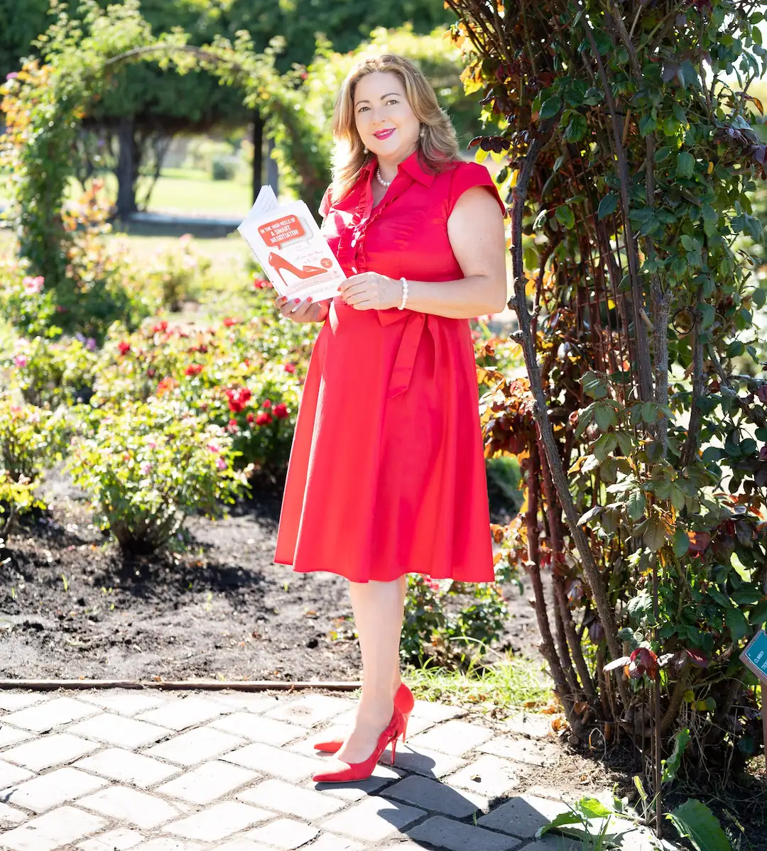 Yvette Durazo reading her book in a beautiful garden setting